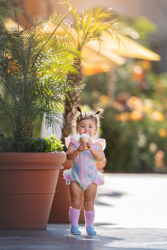 Little girl in Los Angeles enjoying her very first ice cream while the sun is shining