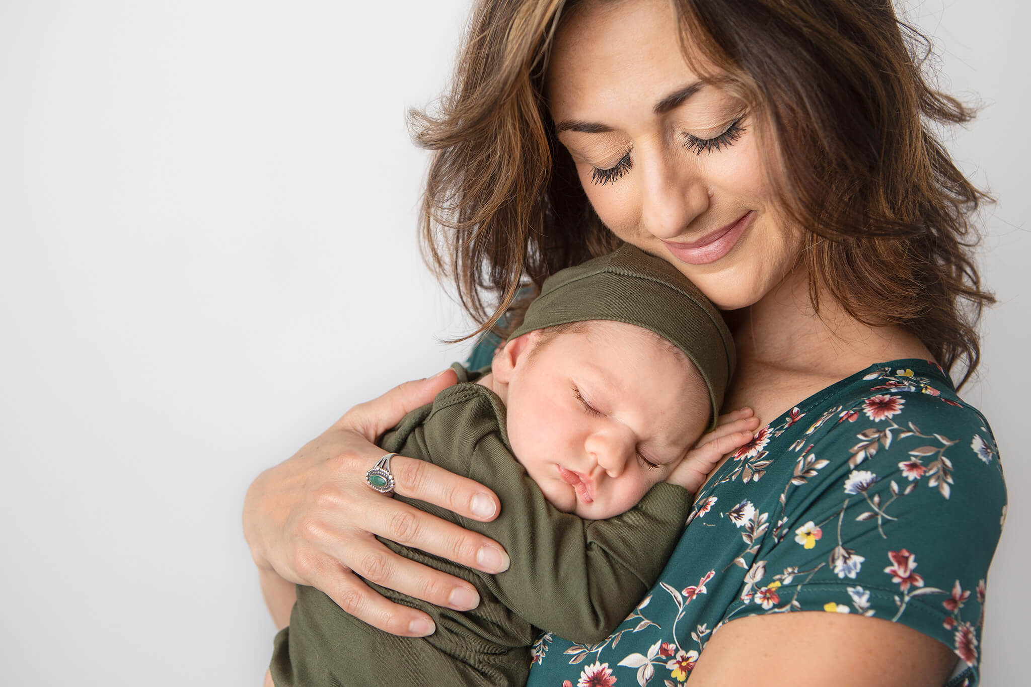 Mom snuggling her newborn baby at newborn photoshoot in LA - Los Angeles Pediatricians