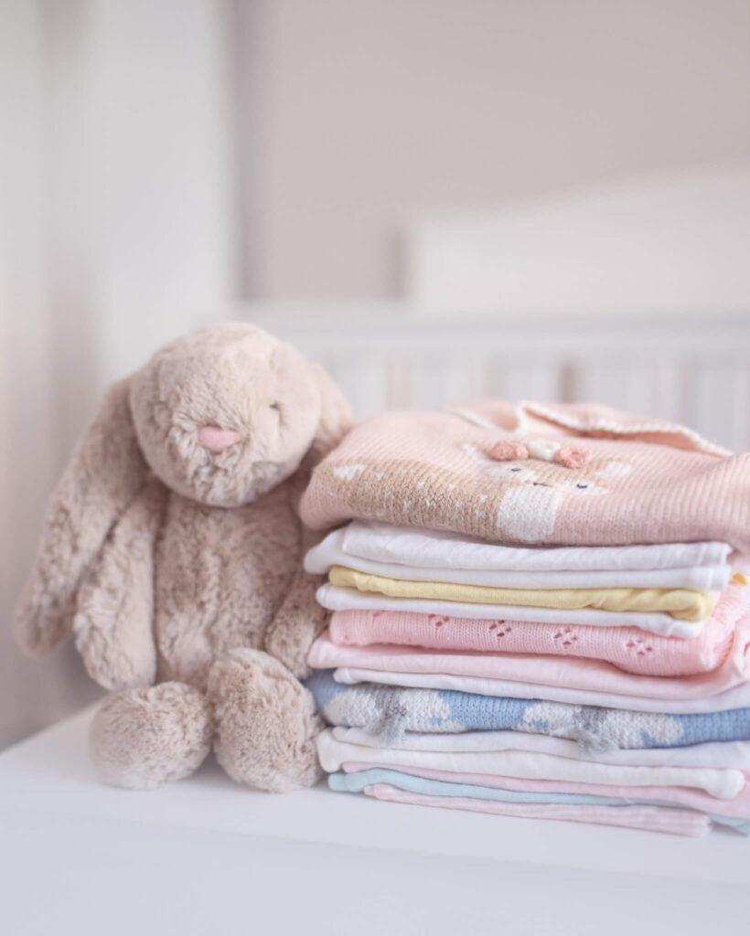 Image of a jelly cat rabbit teddy with a pile of girl clothes photographed in LA 