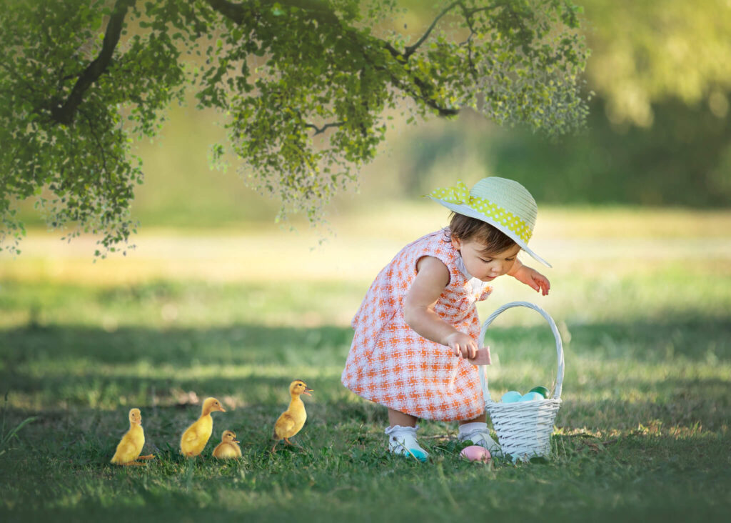 Little girl wearing a Janie and Jack dress for her Spring photoshoot in Los Angeles with little ducklings following her along. Image by Elsie Rose Photography
