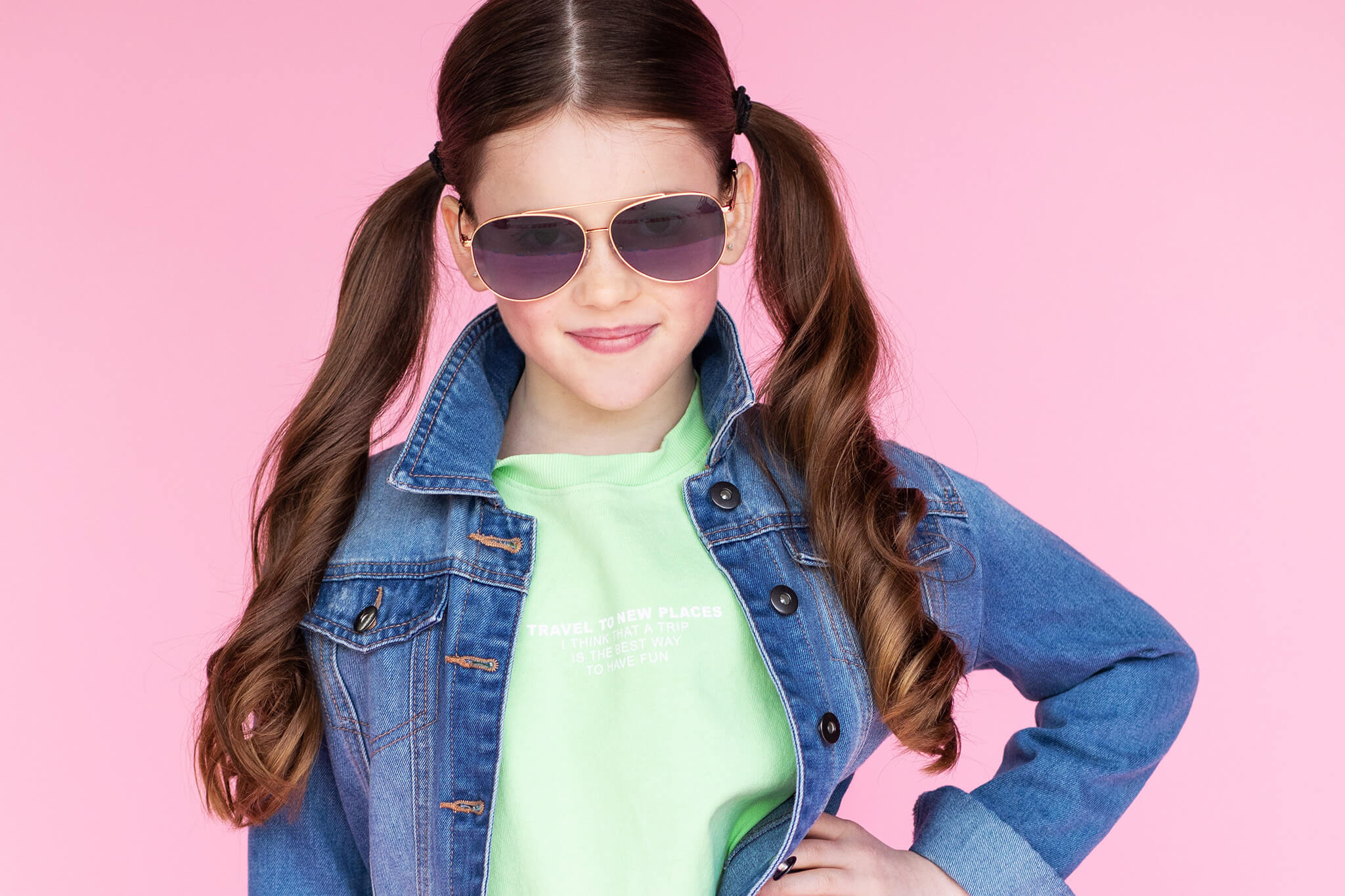 Girl wearing sunglasses in LA on a pink backdrop summer-camps-in-pasadena