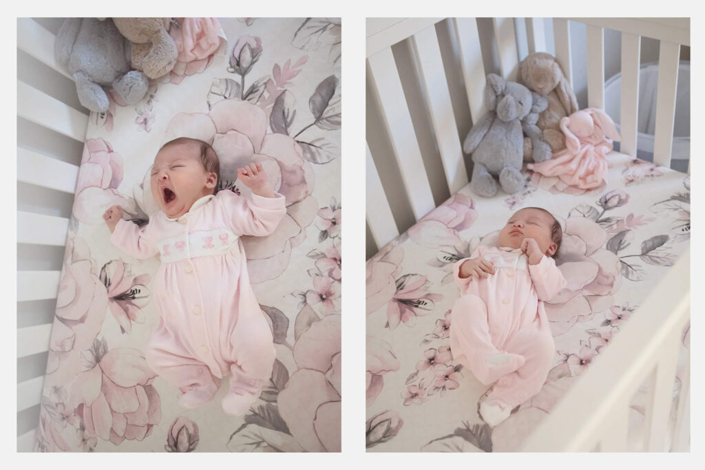 Newborn baby girl laying in her crib, two weeks old wearing cute pink sleepsuit - Baby Furniture Los Angeles