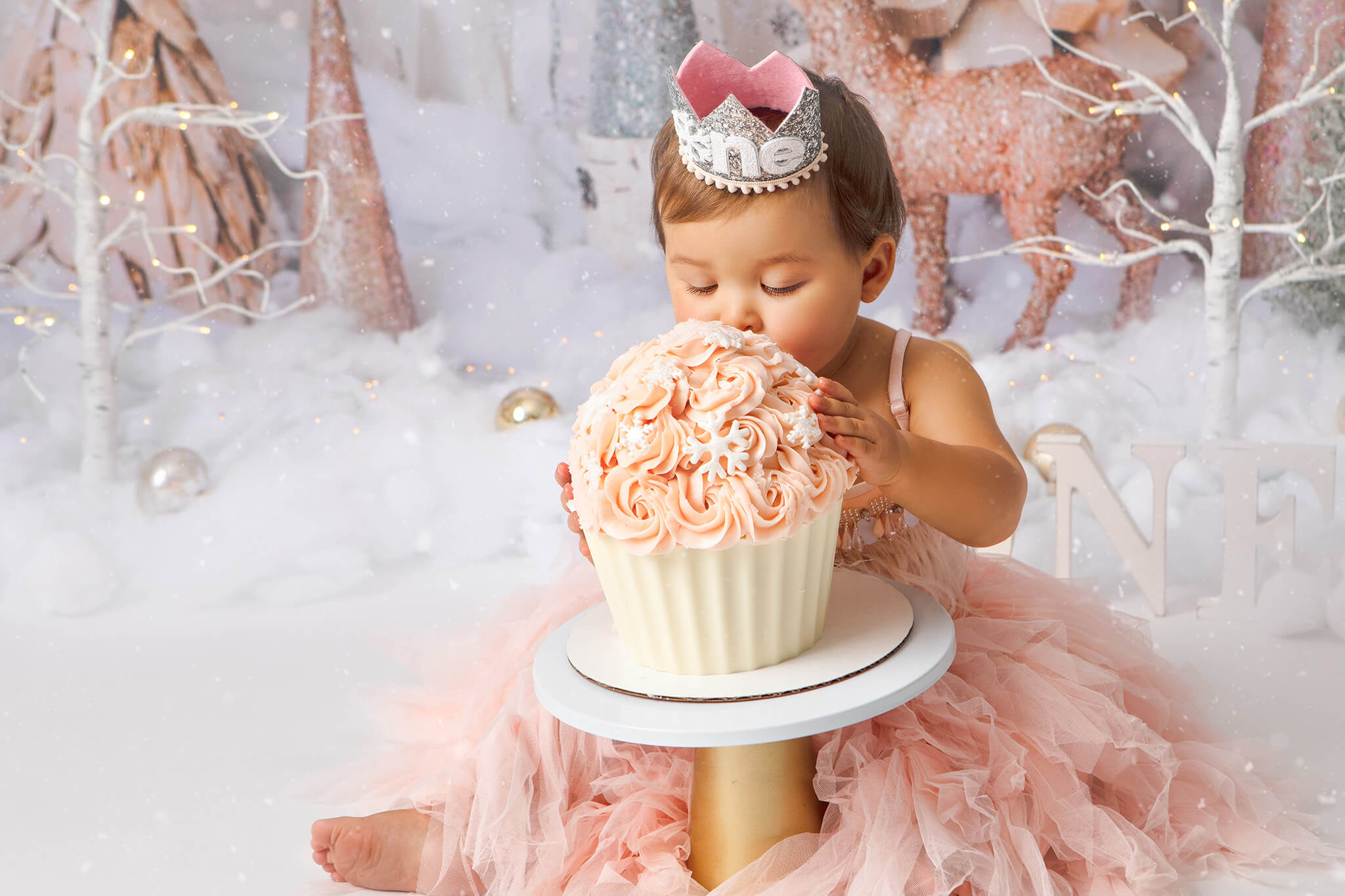 Baby girl with eyes closed eating her first giant cupcake for her birthday - Best Birthday Cakes in Los Angeles