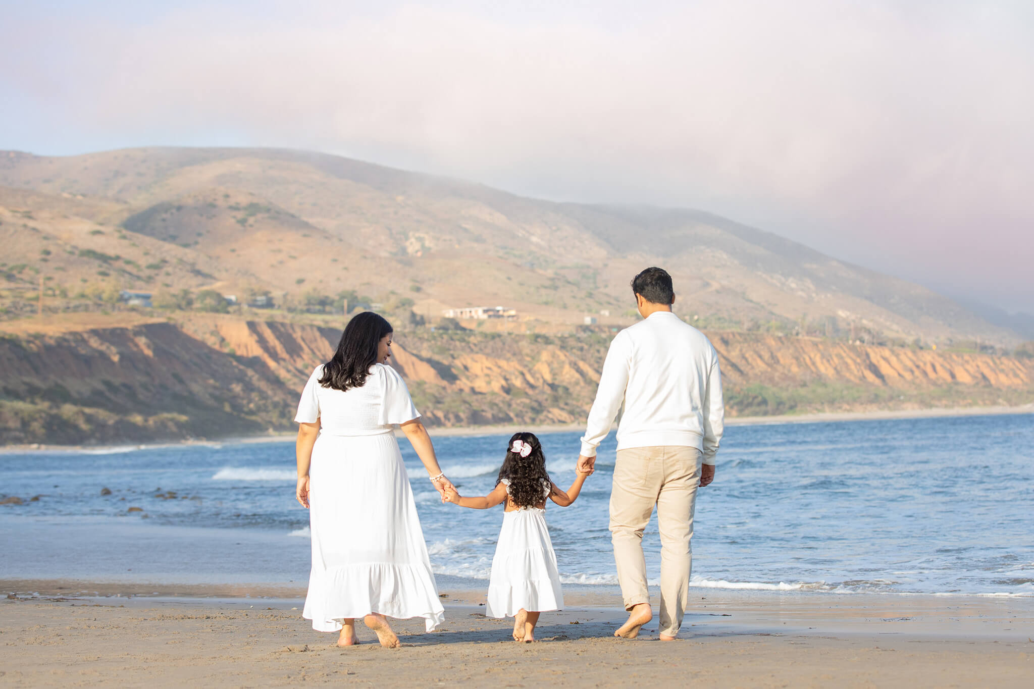 Family walking towards the water in the evening at Malibu with Elsie Rose Photography - Beverly Hills Hotels