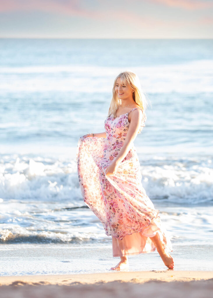 Teen girl at the beach in Malibu wearing a pink dress at sunset - High School Senior Portraits