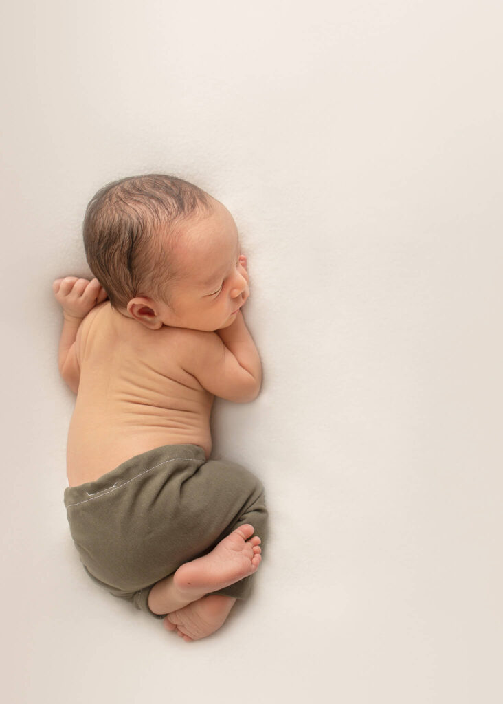 Tiny newborn baby boy in newborn photoshoot in LA with Elsie Rose Photography