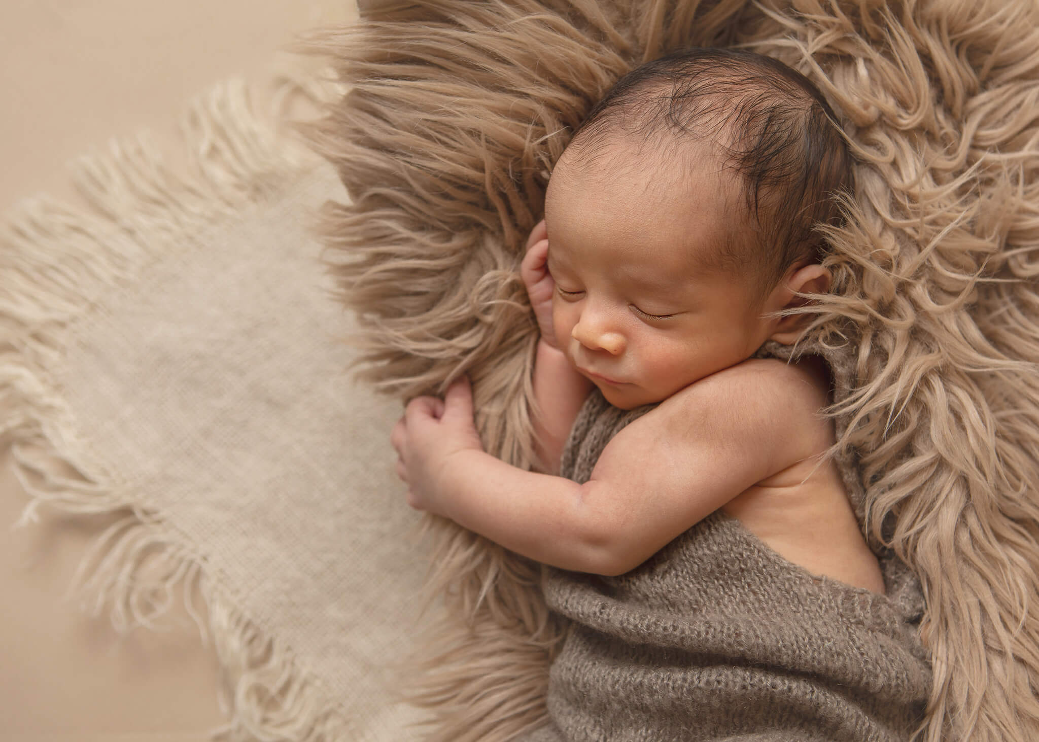 newborn baby boy laying on fur blanket asleep taken by newborn photographer Elsie Rose Photography in LA