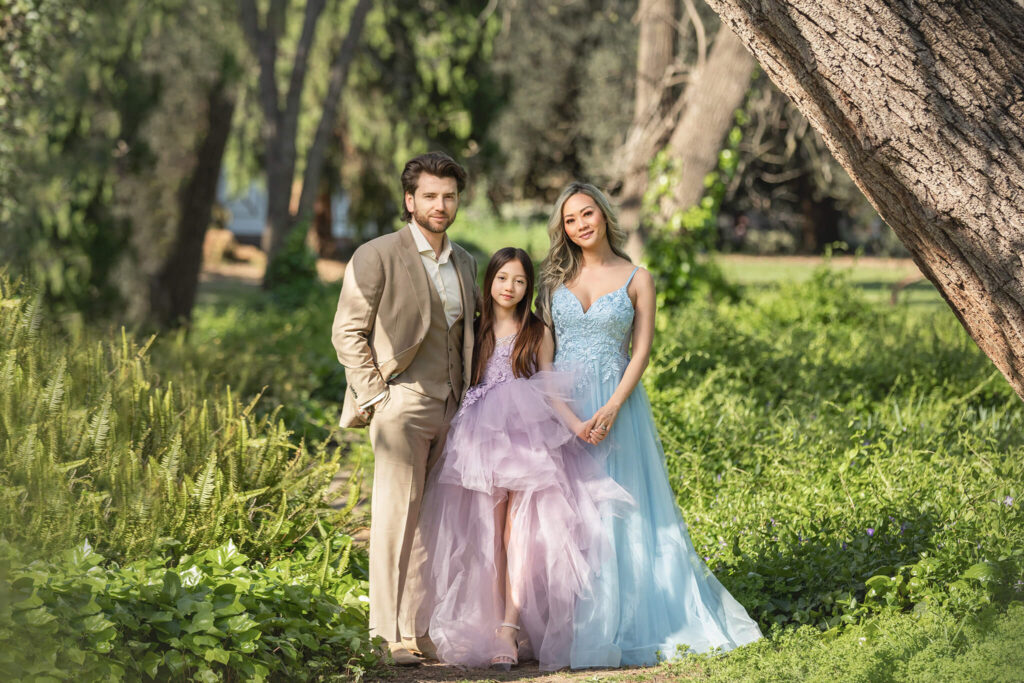 Family of three - mom, dad and daughter smiling at Los Angeles Arboretum photoshoot with Elsie Rose Photography