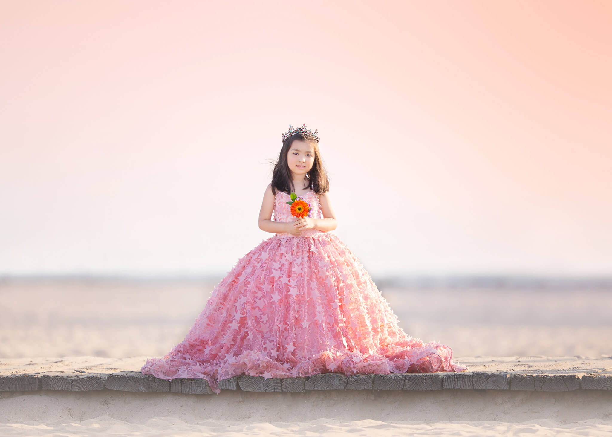 Little girl wearing a couture princess gown at the beach in Malibu with sunset sky - santa monica beach hotels