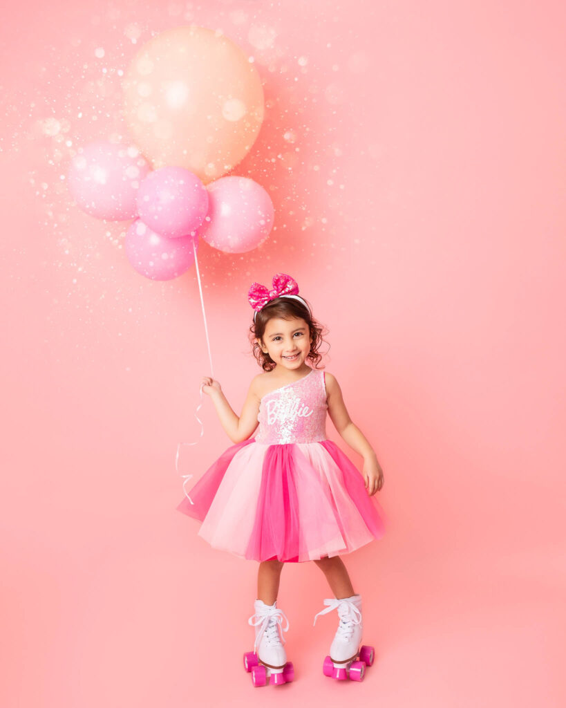 Little girl in roller skates and barbie dress for a birthday photoshoot in Woodland Hills