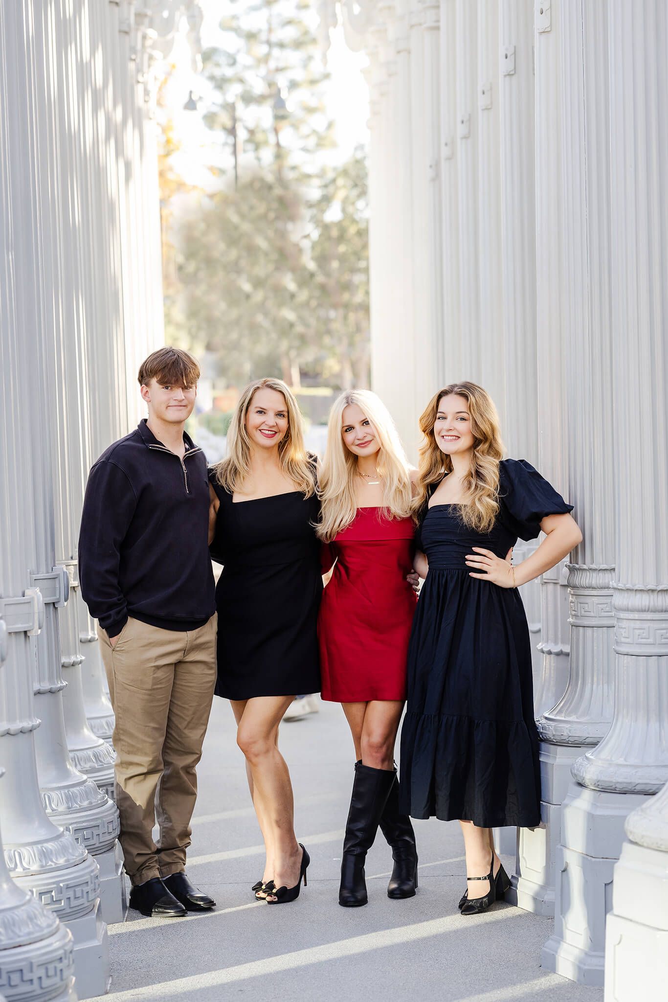 Mom and her grown children posing in the LACMA lamps for a photoshoot