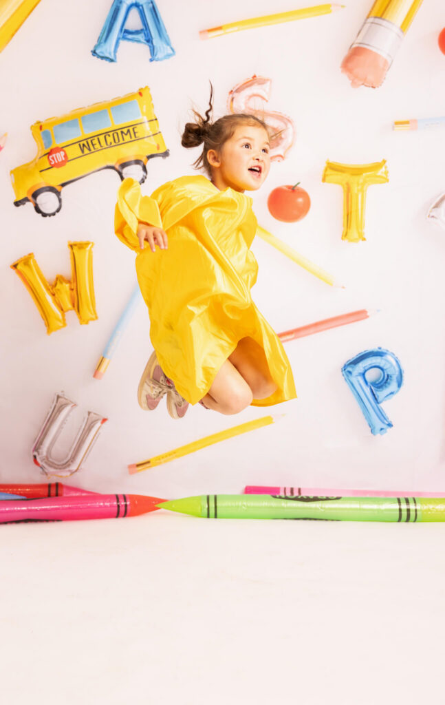 Preschool and kindergarten graduation in LA. Preschooler jumping in the air with Elsie Rose Photography capturing the shot.