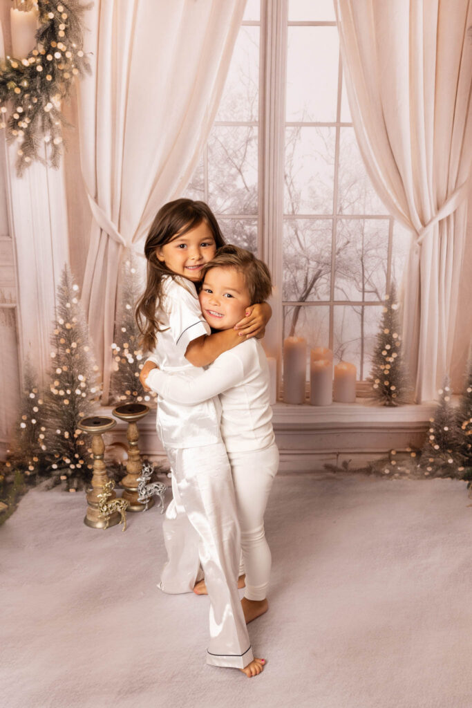 Toddler brother and sister cuddling at Christmas time