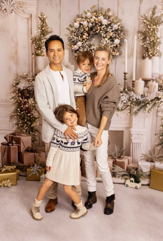 Family in LA at a Christmas photoshoot with Elsie Rose Photography with a white and gold background