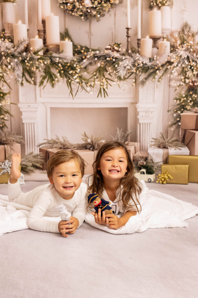 Two little children laying on the ground playing - Christmas Activities in Los Angeles