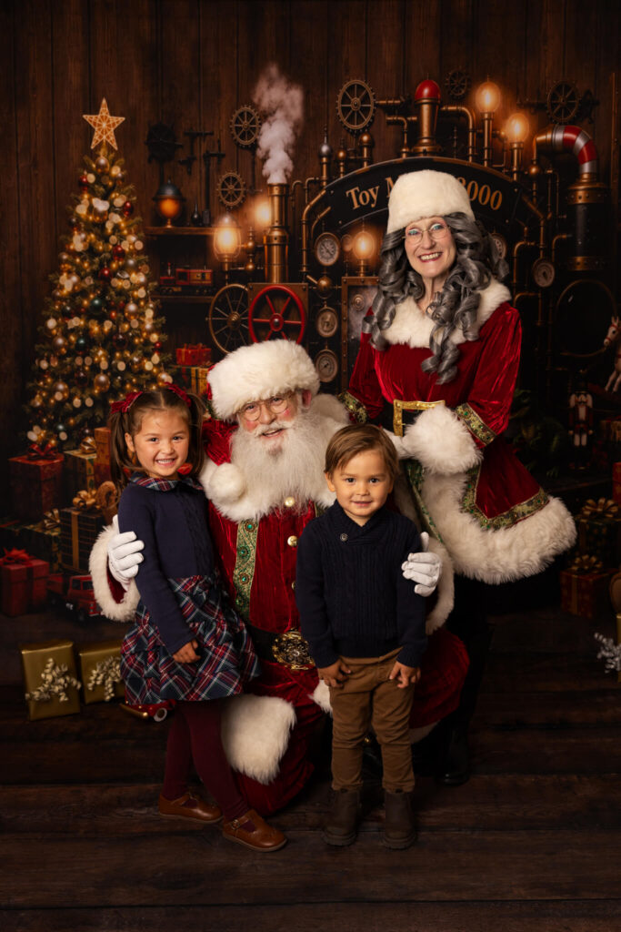 Two children posing for pictures with Santa in Los Angeles