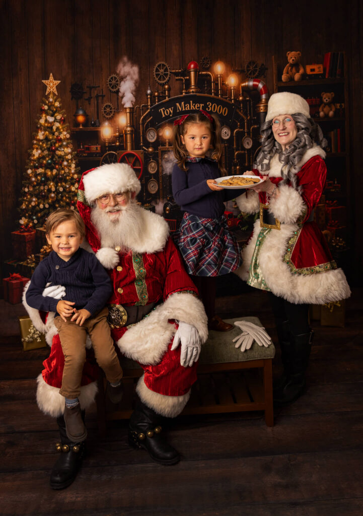 Cookies on a plate being held by a little girl in Los Angeles with Santa and Mrs Claus