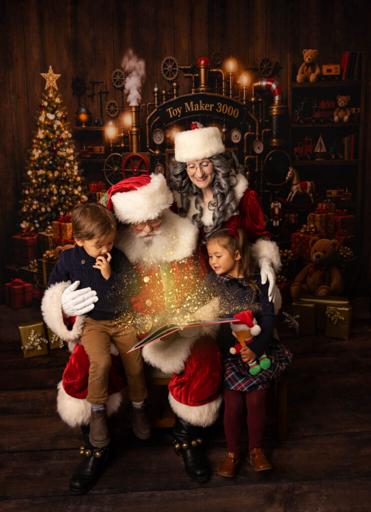 Santa and Mrs Claus with two little children reading a magical book at Christmas time