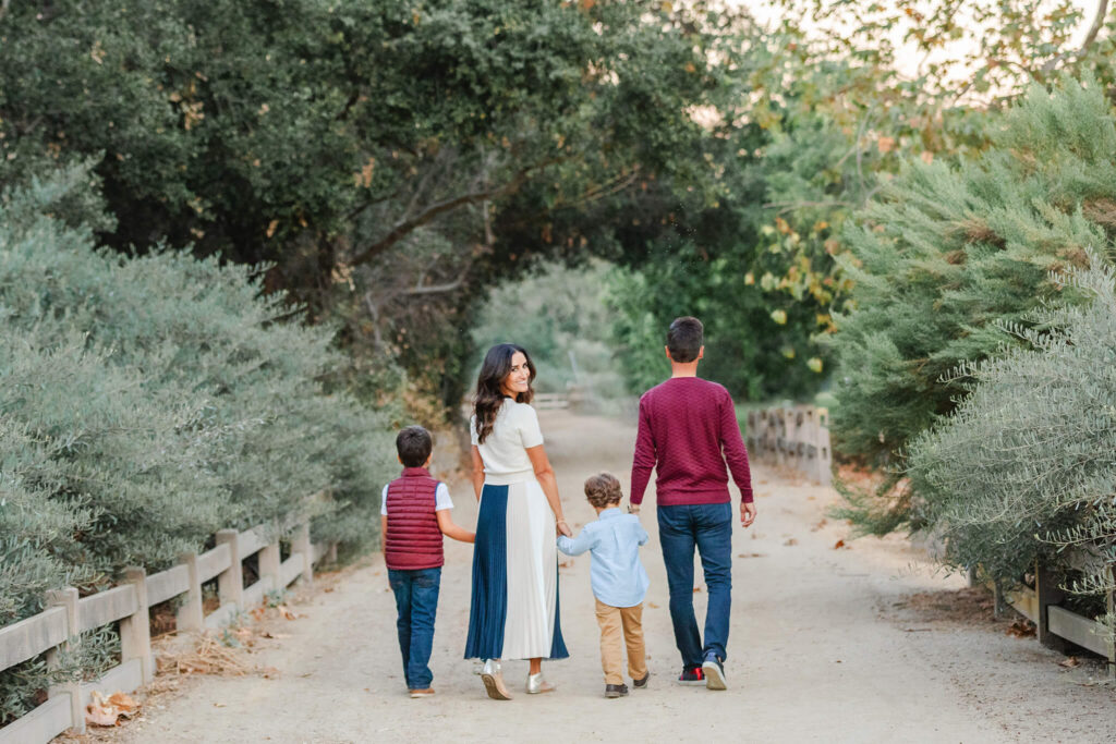 Family of 4 walking away from the camera at photoshoot in LA with Elsie Rose Photography. Things to do in LA in october.